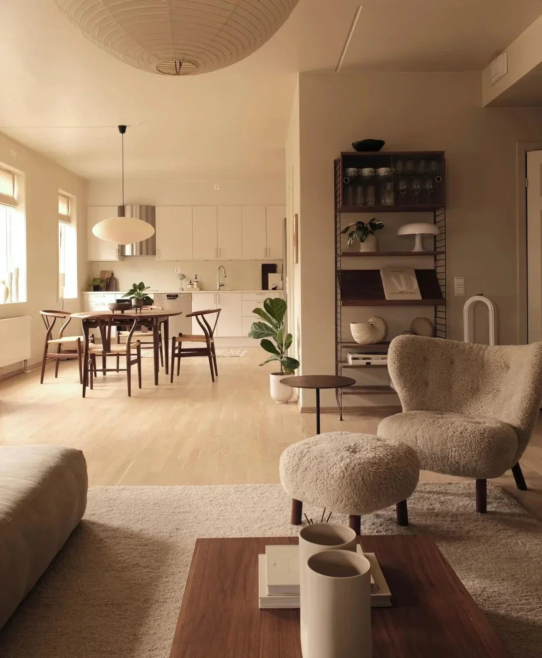 Open-plan Scandinavian living space with soft neutral tones and ceramic vases, styled by @niblu.home