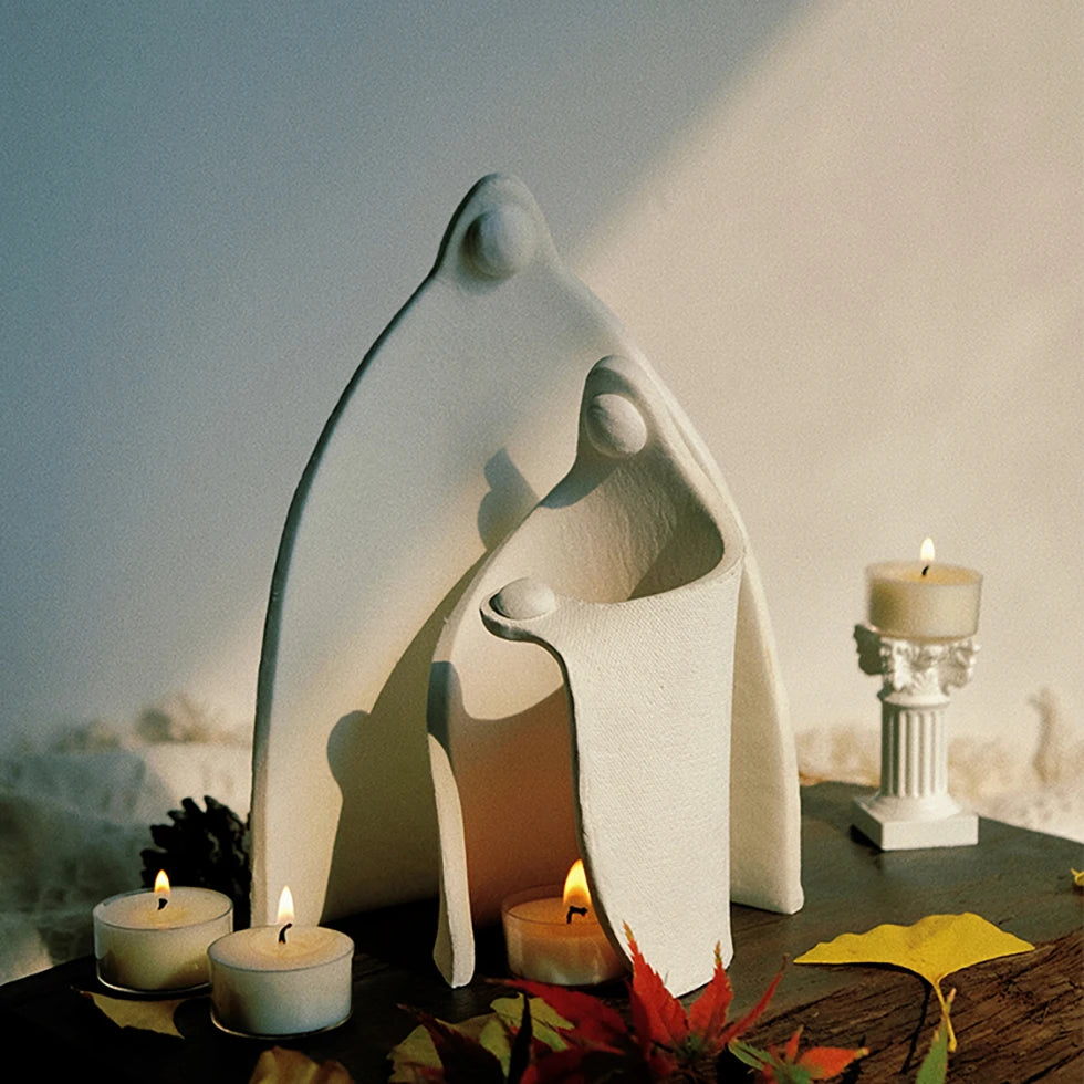Ceramic family candle holder on a wooden table with burning tealights