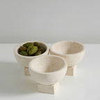 Elegant beige marble bowl used as a snack dish for olives and berries