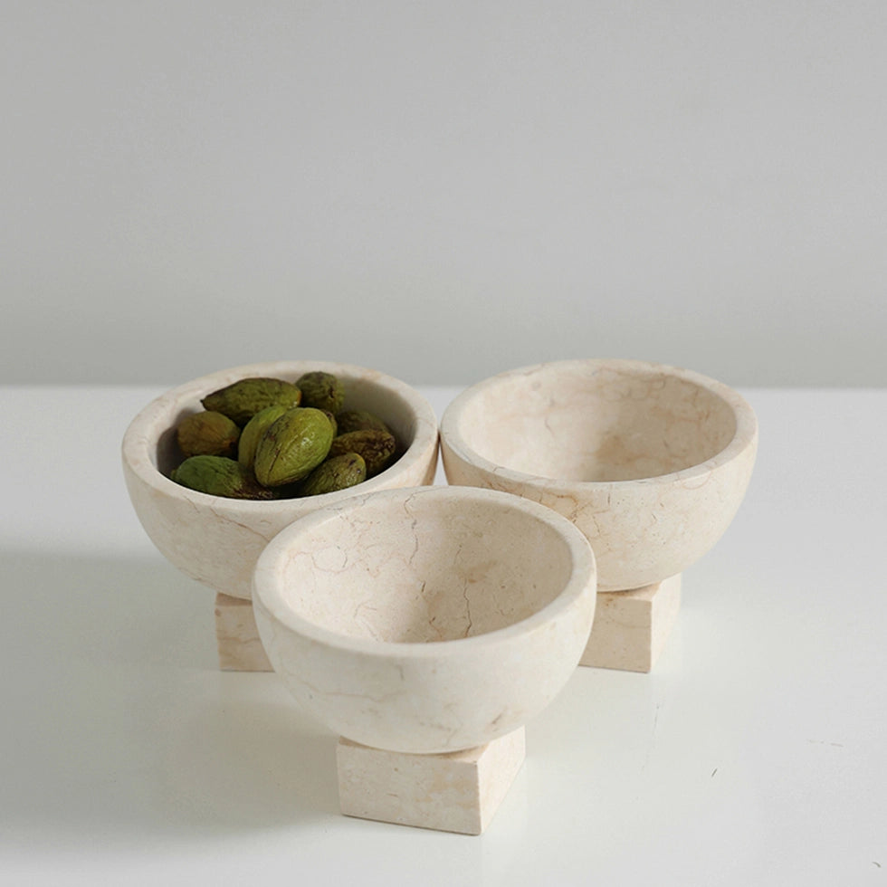 Elegant beige marble bowl used as a snack dish for olives and berries