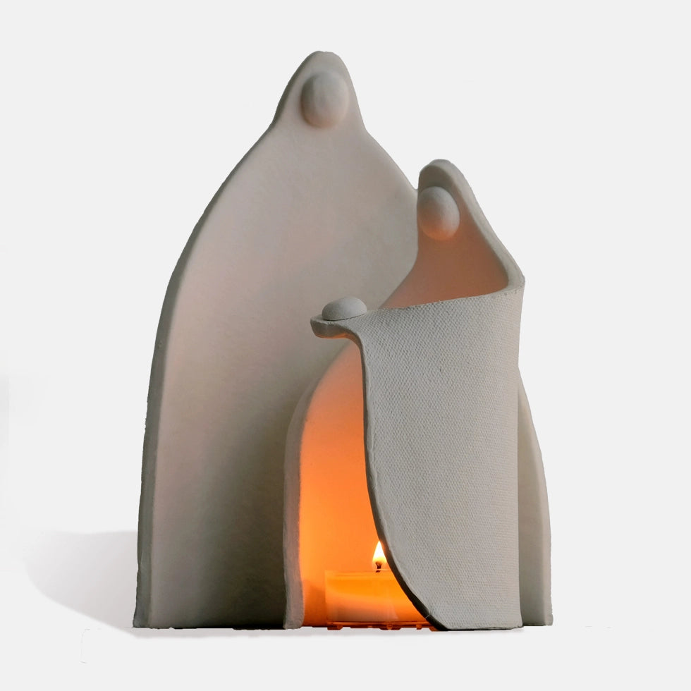 Guardian ceramic candle holder glowing with tealight inside