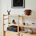 Black candle holders on a shelf