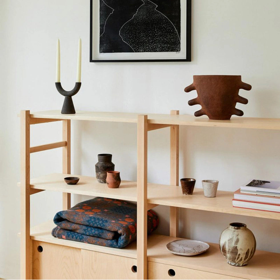 Black candle holders on a shelf