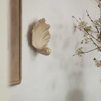 Artistic wall-mounted shell candle holder adding vintage charm