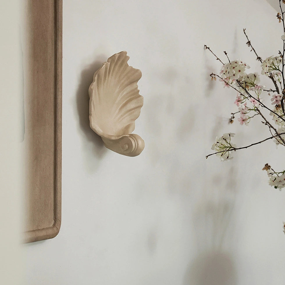 Artistic wall-mounted shell candle holder adding vintage charm