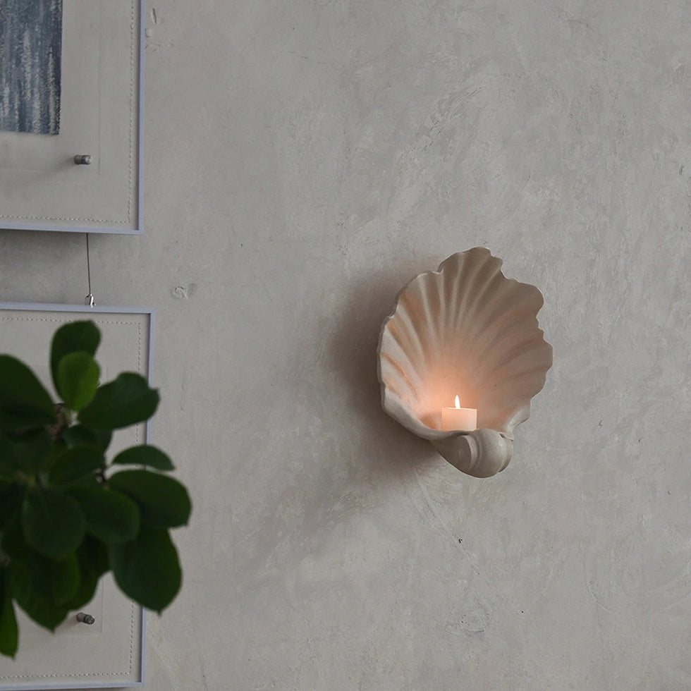 vintage resin shell wall candle holder with candle glowing on wall