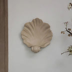 Off-white resin shell-shaped wall sconce for candles and decor